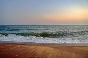 Radiant Prints: A tranquil beach of Indian ocean in Hambantota with foamy waves at sunset