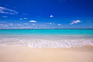 Tranquil beach scene. Exotic tropical beach landscape. Design of summer vacation holiday concept, waves, sea horizon over white sand with blue sky