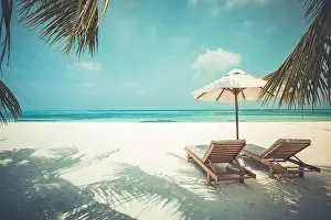 Tranquil beach scene. Exotic tropical beach resort, landscape for background or wallpaper. Luxury beach with loungers, chairs under umbrella palm sand