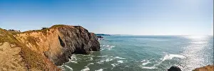 Beachfront Prints: A tranquil beach scene featuring a collection of large rocks situated in the center of the frame