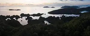 A tranquil sunrise greets the limestone islands in Raja Ampat, Indonesia. This region is thought to be the world's epicenter of marine biodiversity