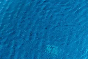Blue Hues Prints: The tranquil turquoise waters gently undulate under the sun