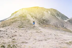 Climber Prints: Traveler with a backpack climbs the mountain