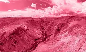 Altay Prints: Trendy Color of the year 2023: Viva Magenta toned aerial drone view of eroded landform of Altai mountains