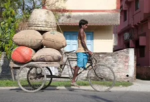 Sack Prints: Tricycle rickshaw rider struggles with heavy load Cooch Behar, West Bengal, India