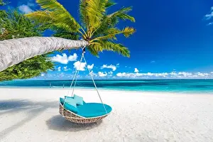 Tropical beach background as summer landscape with beach swing or hammock and white sand and calm sea for beach banner. Perfect beach scene vacation