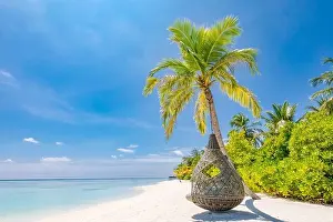 Tropical beach background as summer landscape with beach swing or hammock and white sand and calm sea for beach banner. Perfect beach scene vacation