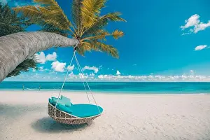 Tropical beach background as summer landscape with beach swing or hammock and white sand and calm sea for beach banner. Perfect beach scene vacation