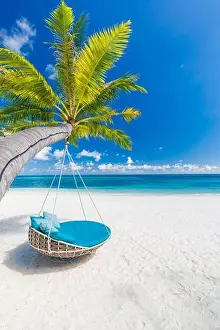 Tropical beach background as summer landscape with beach swing or hammock and white sand and calm sea for beach banner. Perfect beach scene vacation