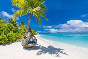 Tropical beach background as summer landscape with beach swing or hammock and white sand and calm sea for beach banner. Perfect beach scene vacation