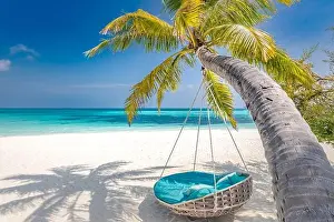 Tropical beach panorama as summer landscape with beach swing or hammock and white sand and calm sea for beach banner. Perfect beach scene vacation
