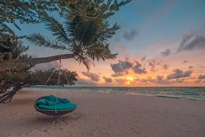 Tropical beach sunset landscape with beach swing or hammock and sunset sky white sand and calm sea for beach banner. Perfect beach scene vacation