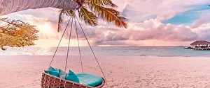 Tropical beach sunset panorama as summer landscape with beach swing hammock and white sand, calm sea for beach banner. Perfect beach scene vacation