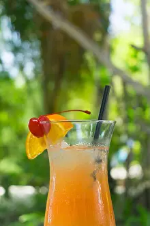 Vodka Prints: Tropical cocktail with orange and cherry garnish