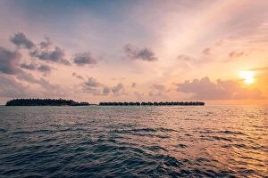 Images Dated 11th March 2019: Tropical island view from sea. Sunset sky clouds, peaceful nature seascape