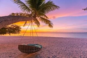 Images Dated 1st June 2019: Tropical sunset beach background as summer landscape panorama with beach swing hammock
