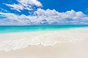 Tropical vacation landscape. Seascape with blue cloudy sky. Relaxing, tranquil, meditational beach view, calm waves. Inspirational beach nature scene