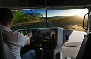 Situation Prints: The truck driver on the road among fields highway. business trip