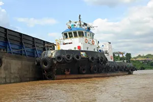 Navigate Prints: Tug boat on side of the empty barge