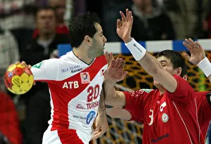 Handball Prints: Tunisian player Haykel Mgannem vies for the ball with Jakob Larsen (R)