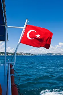 Turkish Flag Prints: Turkey, Istanbul, Turkish flag flying on boat on Bosphorus or Bogazi