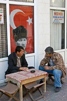 Cappadocia Prints: Turkish Men Smoking and Talking in front of a Poster of Ataturk in Cappadocia Turkey