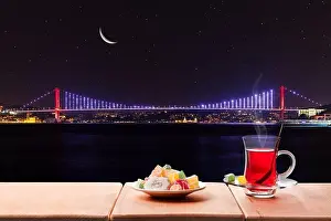 Moonlight Prints: Turkish tea party near the Bosphorus bridge at night, Istanbul, Turkey