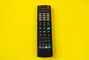 Black Hand Prints: tv remote isolated on yellow background