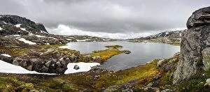 Images Dated 18th July 2017: Typical norwegian landscape with snowy mountains and clear lake near the Trolltunga rock - most