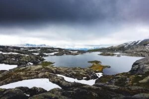 Images Dated 18th July 2017: Typical norwegian landscape with snowy mountains and clear lake near the Trolltunga rock - most