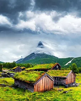 Typical norwegian old wooden houses with grass roofs in Innerdalen - Norway's most beautiful mountain valley, near Innerdalsvatna lake