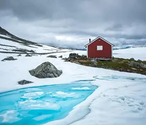 Typical norwegian red wooden house near famous Aurlandsvegen (Bjorgavegen) mountain road in Aurland, Norway in summer time. Landscape photography