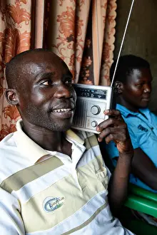Hear Prints: UGANDA, Arua, village Onduparaka, man and family listen radio