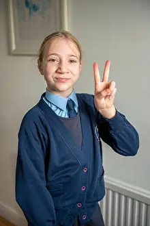 Three Quarter Length Prints: UK, Surrey, Portrait of smiling girl in school uniform