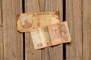 Ruble Prints: Ukrainian hryvnia and Russian ruble lie on a wooden table, economics and finance