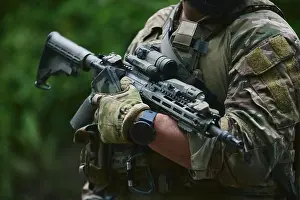 Unrecognizable Prints: Ukrainian soldier equipped with modern assault rifle