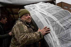 Kherson Prints: Ukrainian soldier, Kolya, is seen carrying some belonging for his team