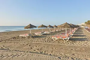 Beachscape Prints: Umbrellas and hammocks on the beachfront of Los Alamos sandy beach in Torremolinos