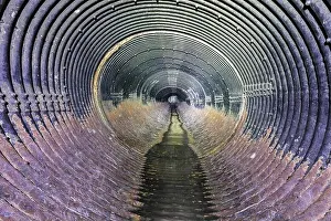 Dump Prints: Underground Drainage Pipe inside an Ocean Shore Creek Tunnel