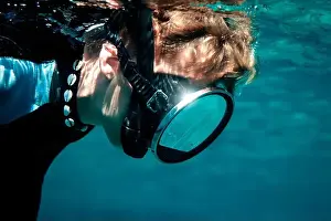 Magnifying Glass Prints: An underwater view of a diver holding a large magnifying glass to observe local fish species in Menorca