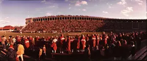 Games Prints: Uniformed players fill the sidelines at a Harvard University football game held in Harvard Stadium