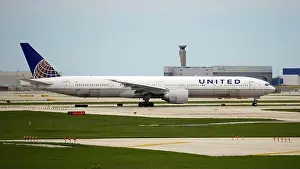 Boeing 777 Prints: United Airlines Boeing 777-300 taxis down the runway after landing at Chicago O'Hare International Airport