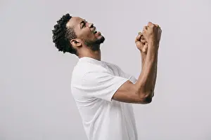 Displeased Prints: upset bearded african american man with clenched fists isolated on grey