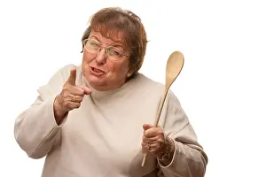 Punishment Prints: Upset Senior Woman with The Wooden Spoon Isolated on a White Background