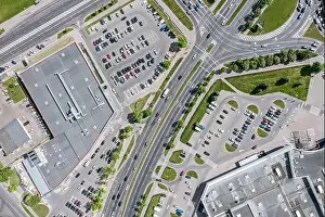 Shopping Center Prints: urban life. shopping center with parking lots and car traffic on city streets