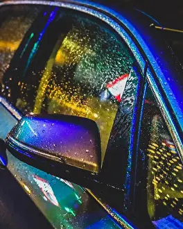 Headlight Prints: Urban night life. Neon reflections on a car