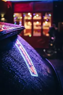 Raindrops Prints: Urban night scene with colourful bright neon lights shining