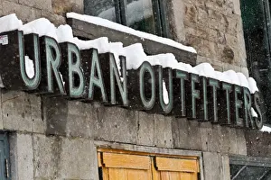 Winter Clothing Prints: The Urban Outfitters sign covered in snow on St. Denis in Montreal, Quebec