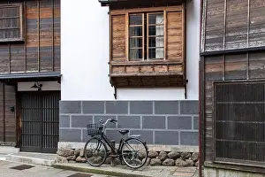 Building House Prints: Urban street view of façade of typical Japanese house with modern stone and traditional wooden window