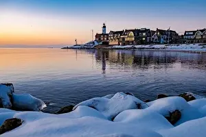 Water Sky Prints: Urk Netherlands lighthouse during winter with snow covered coastline